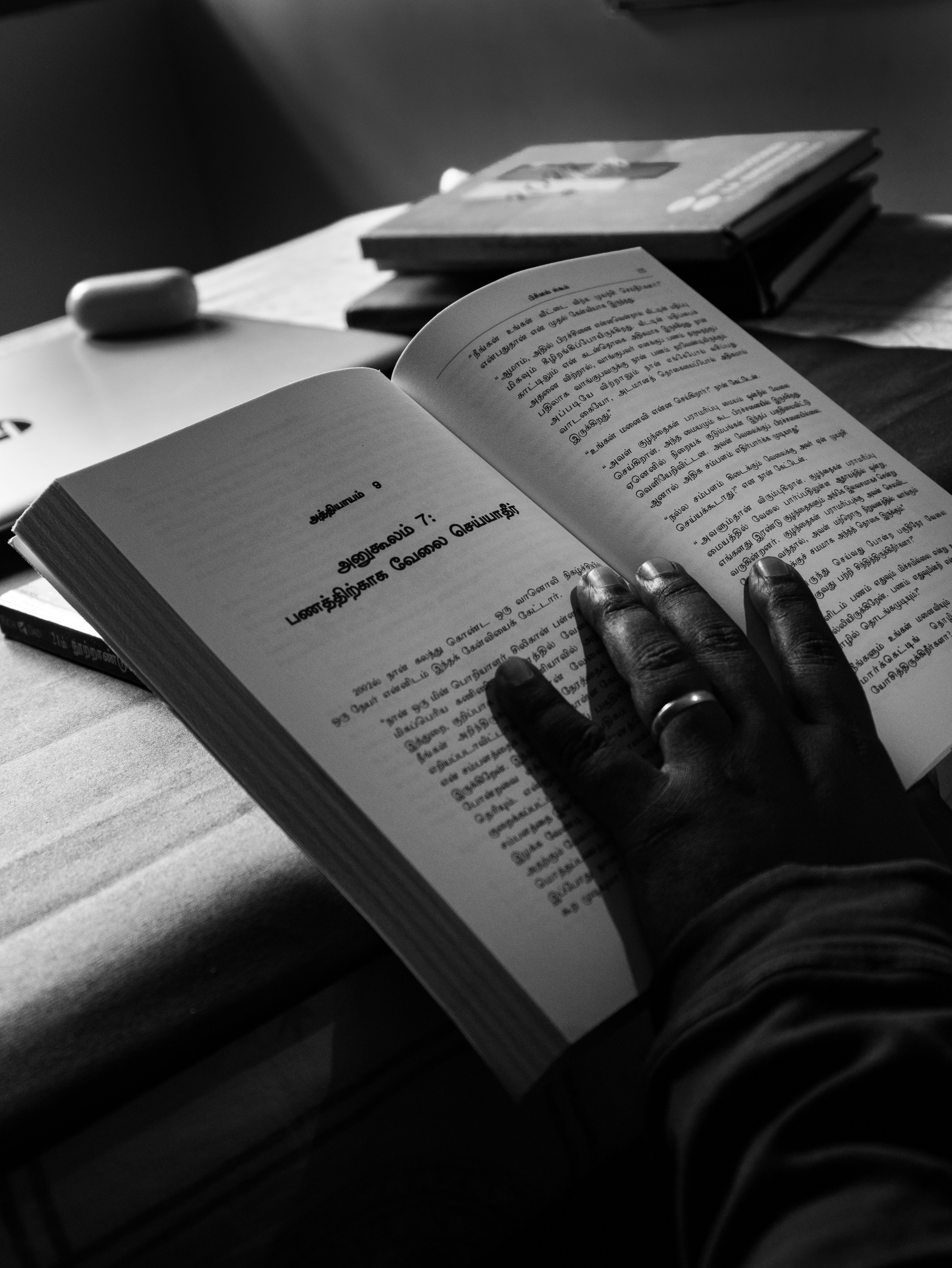 a person is reading a book on a table