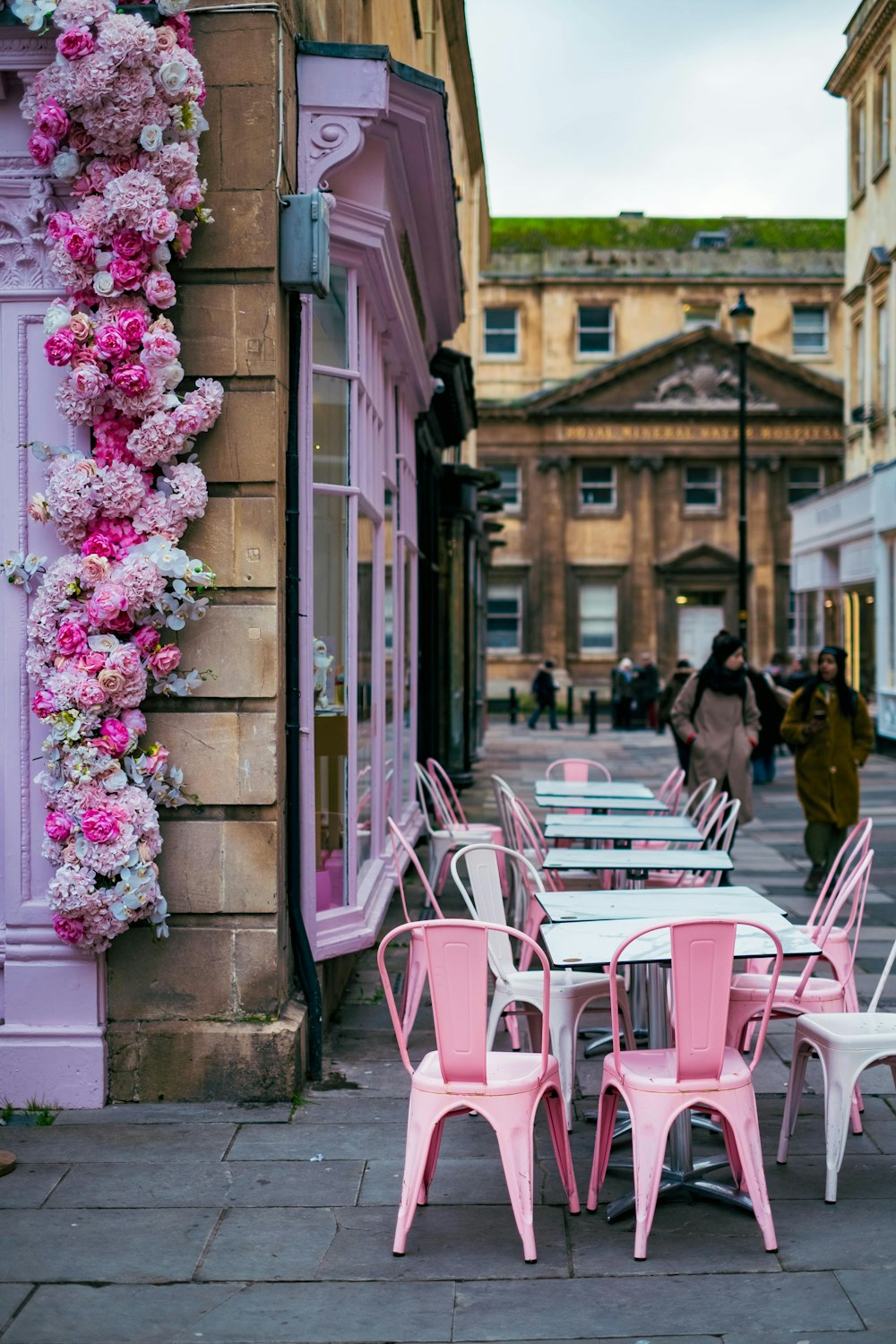 a row of pink and white tables and chairs