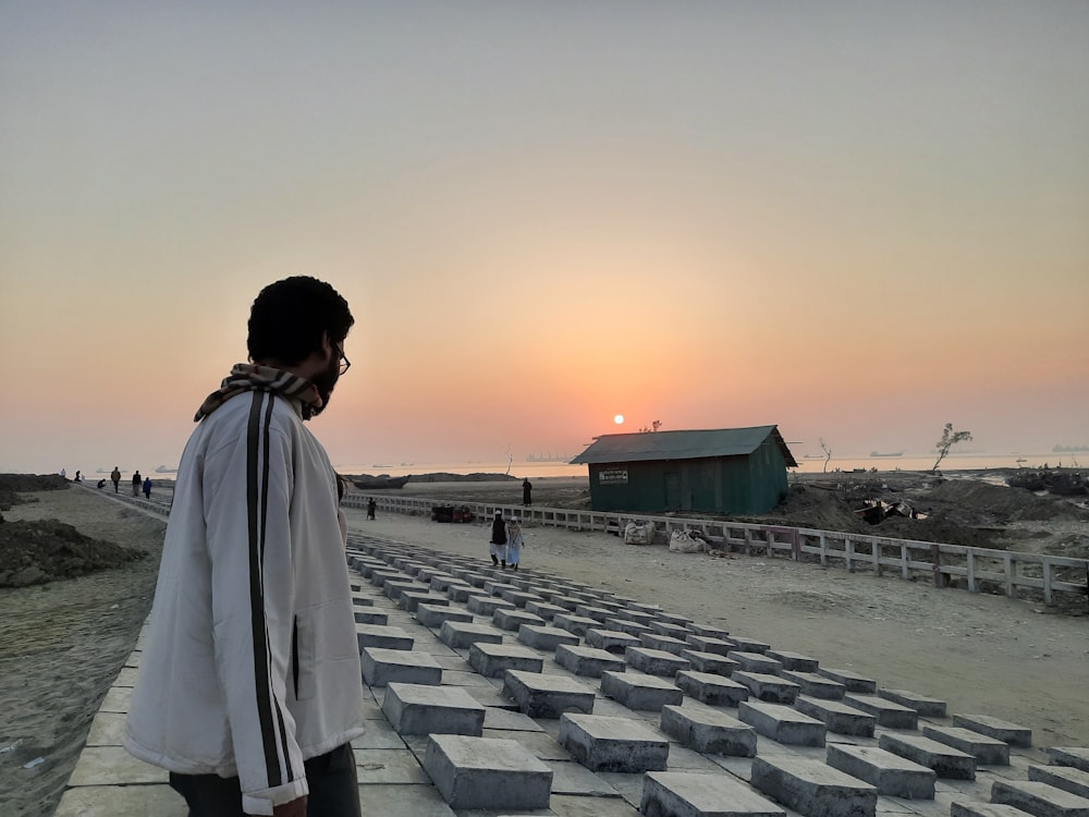 a person standing in front of a field of cement blocks