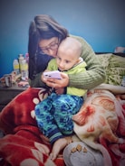 A cozy home setting with a parent and child watching an educational video together on a tablet.