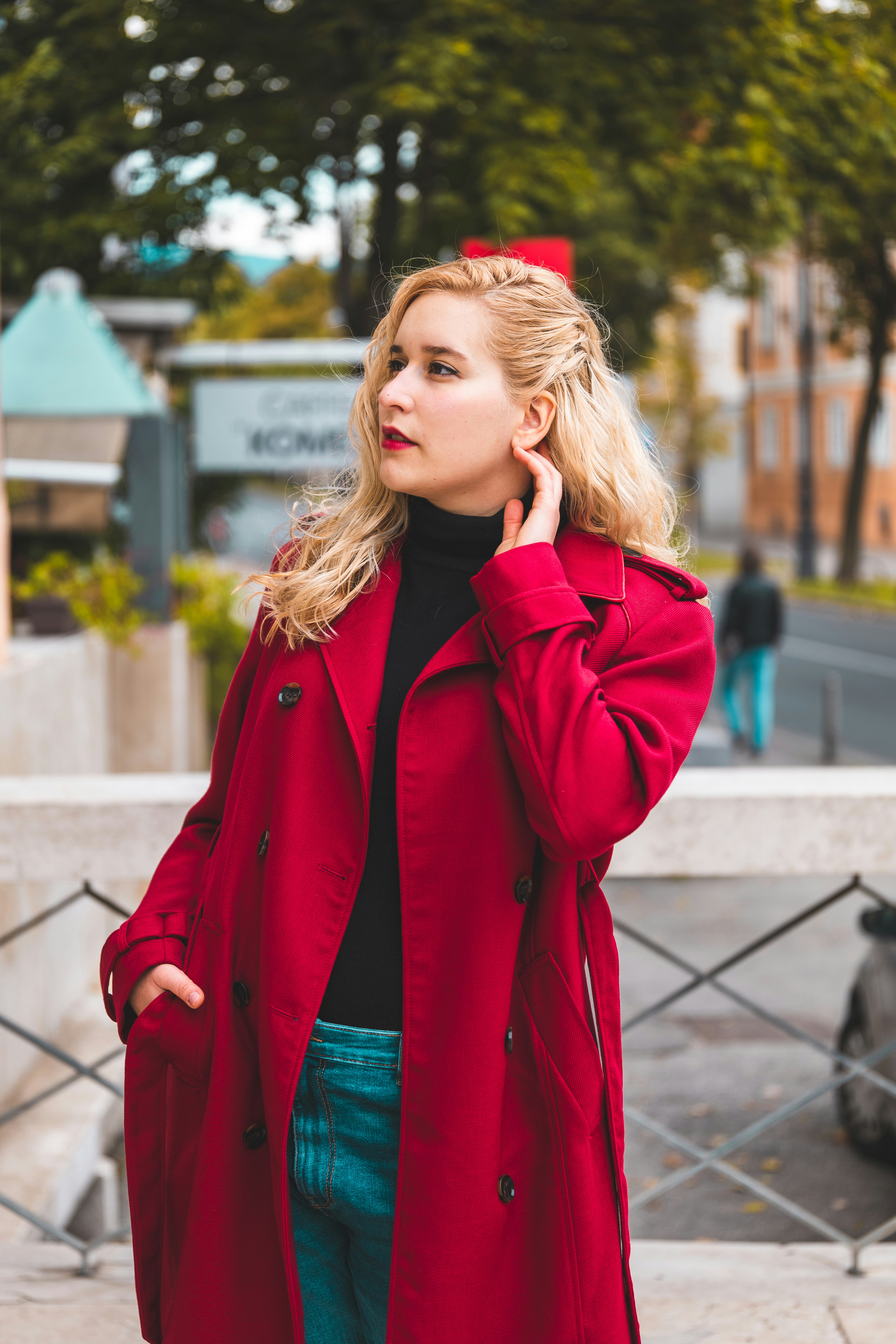 A woman in a red coat talking on a cell phone photo Free Zagreb Image