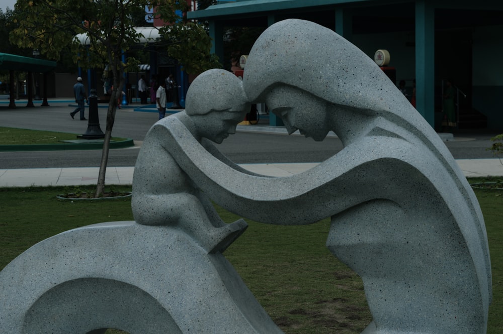 a statue of a woman reading a book