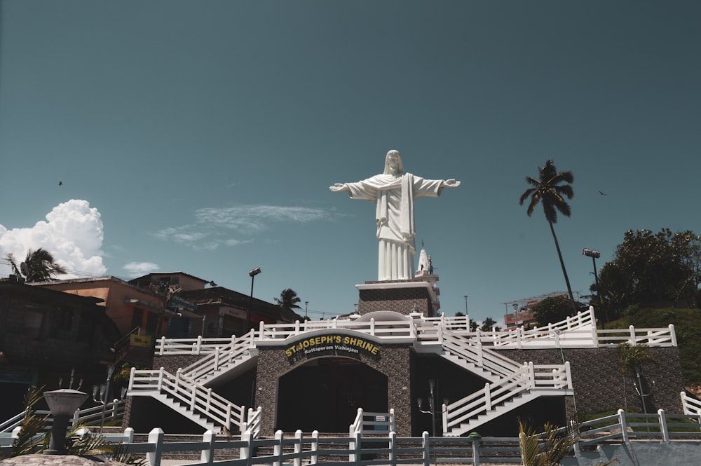 a statue of jesus on top of a building
