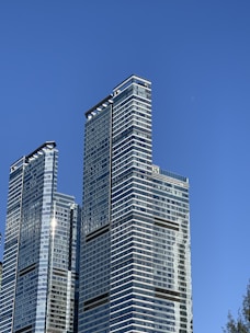 Modern commercial building framework rising against a clear sky.
