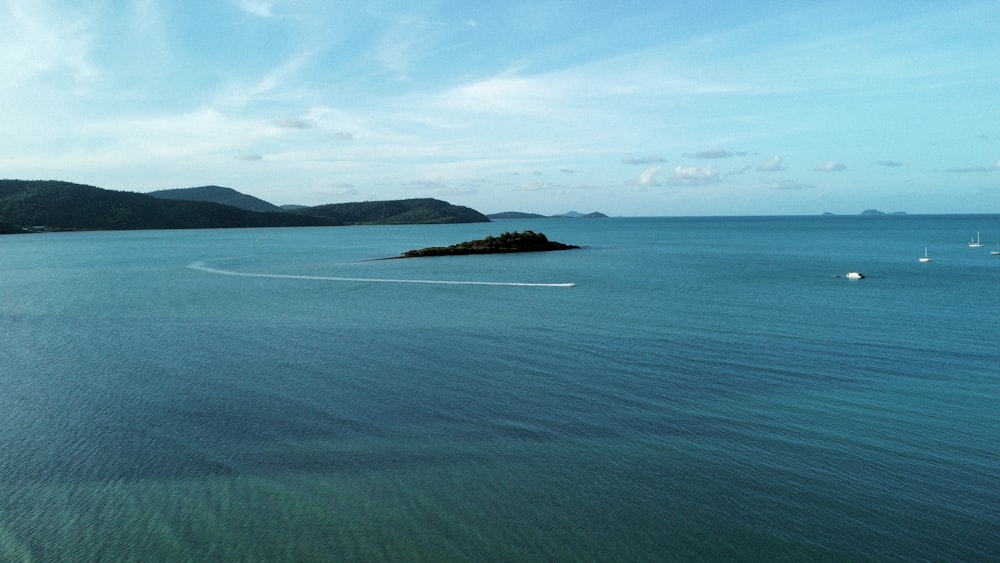 a body of water with a small island in the middle of it