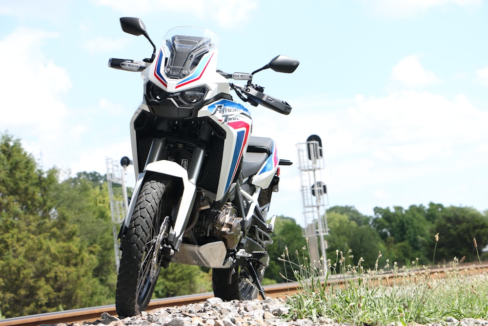 a motorcycle parked on the side of a train track
