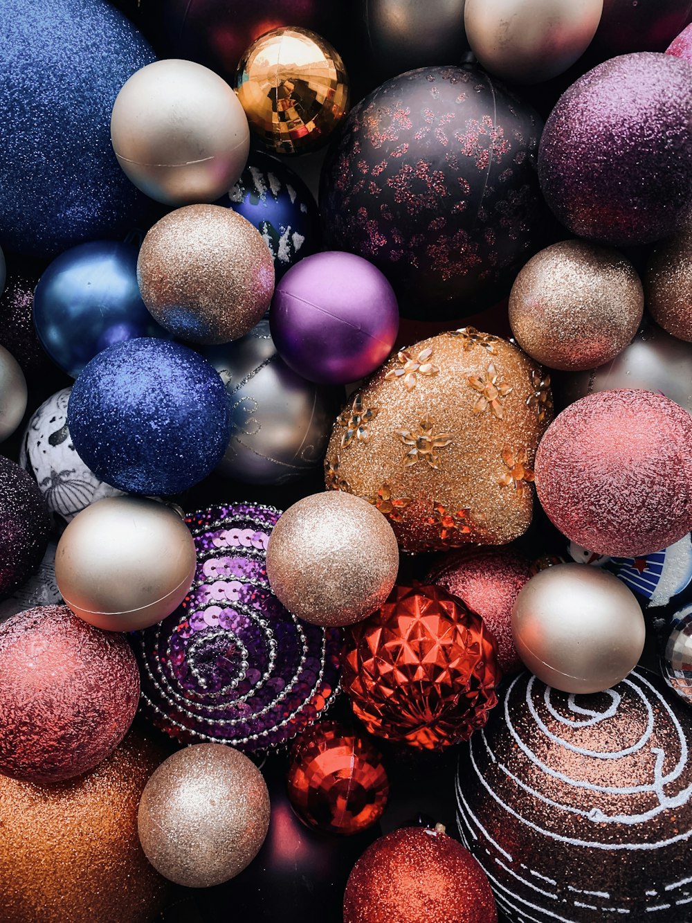a pile of different colored ornaments sitting on top of each other
