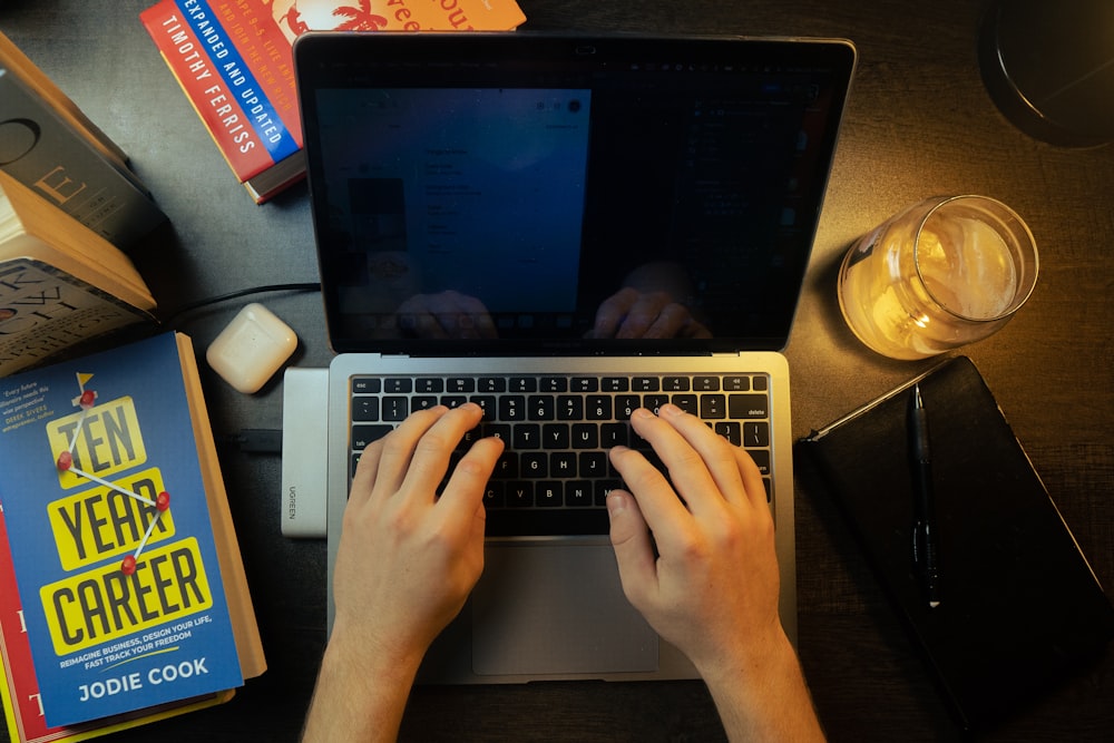 a person typing on a laptop on a desk