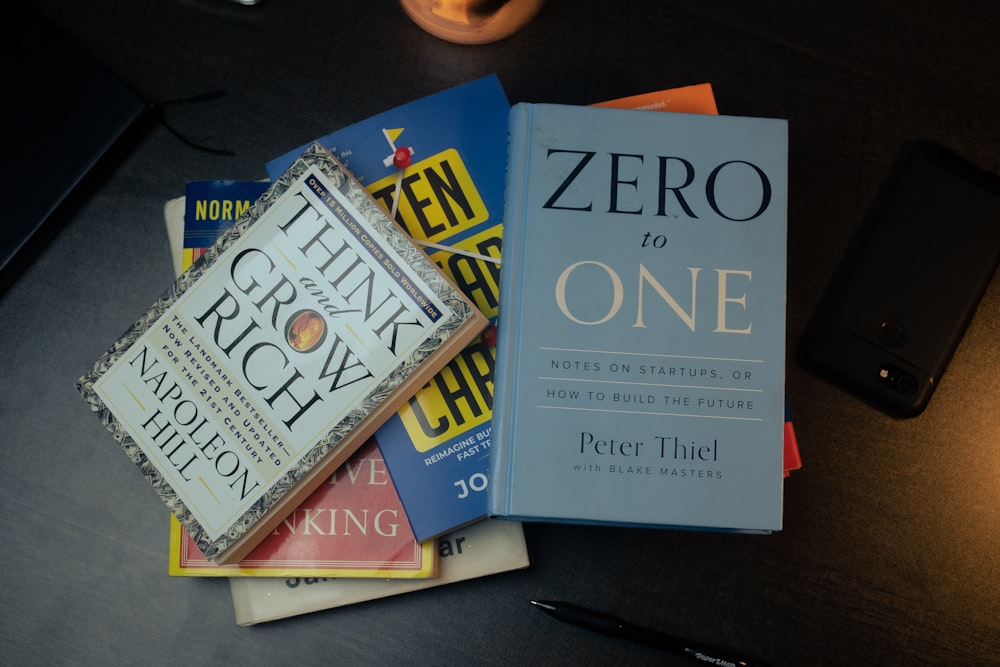 a pile of books sitting on top of a table