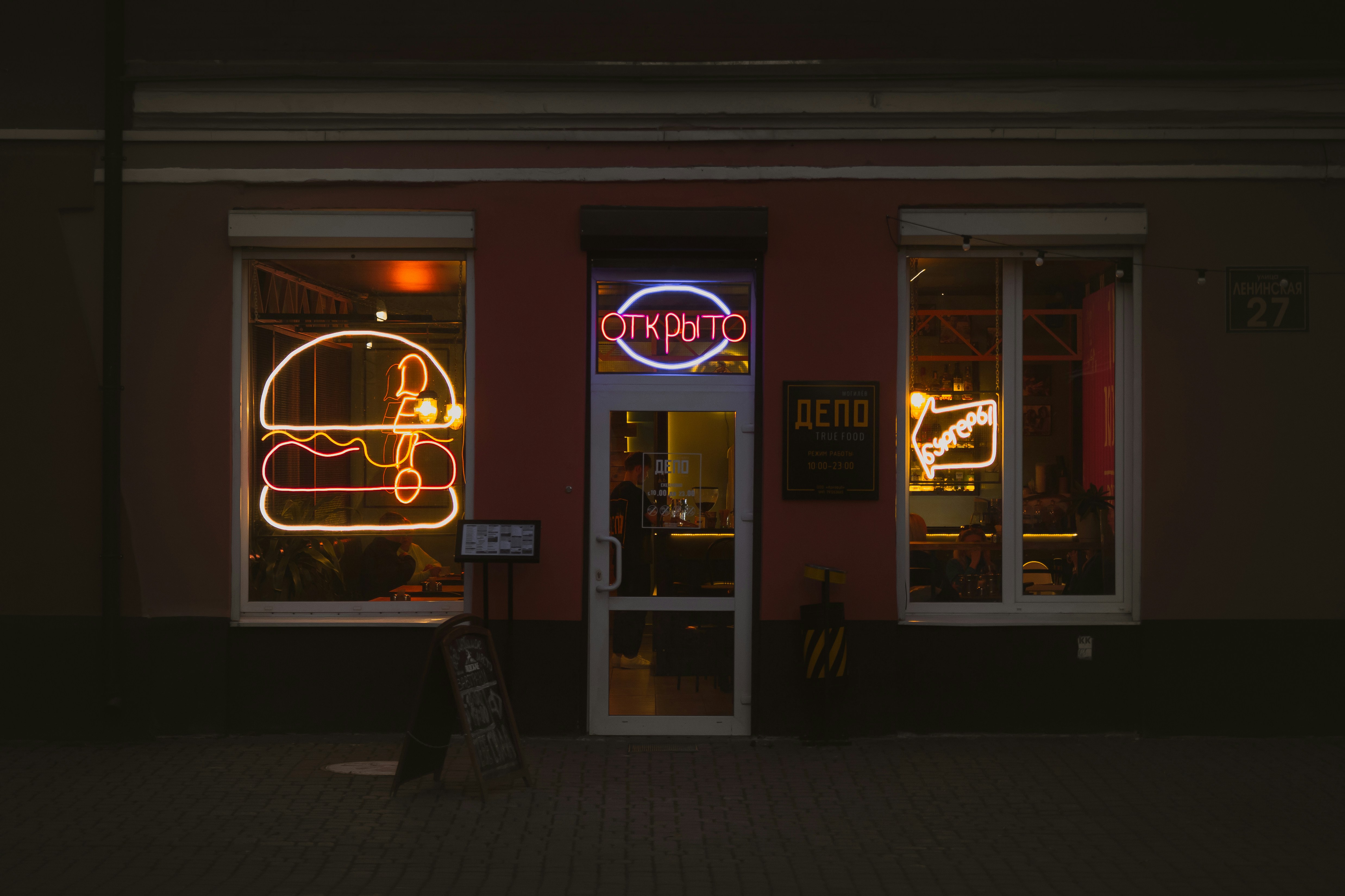 Neon sign in front of restaurant