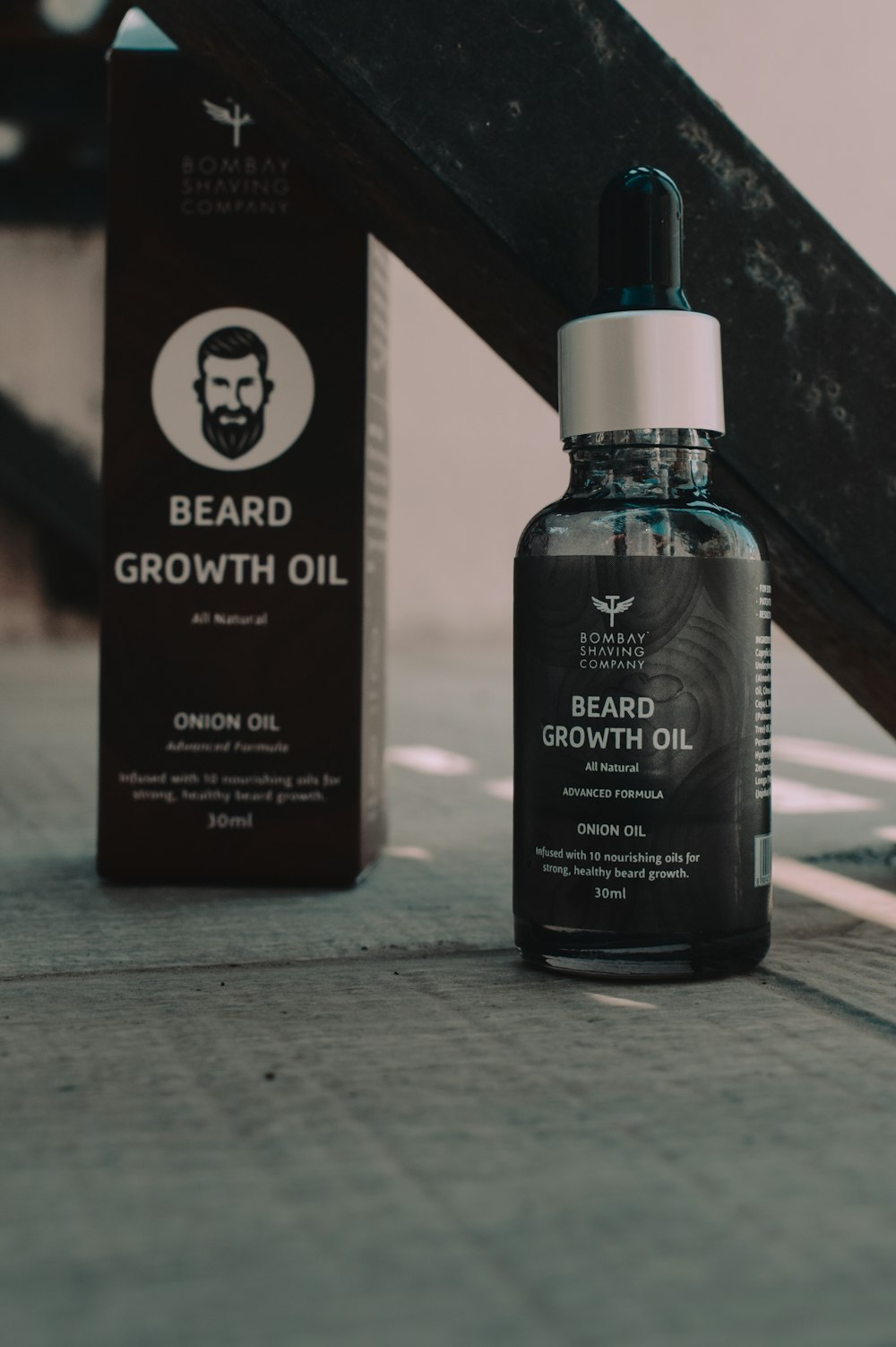 a bottle of beard growth oil next to a box of beard growth oil
