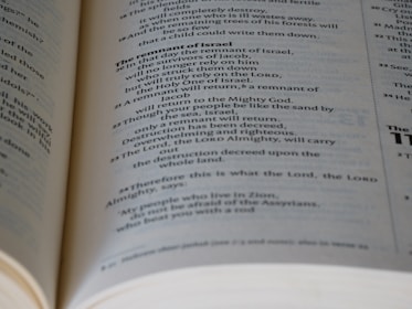 A close-up view of an open Bible, showing text in black print on white pages with a focus on the section discussing 'The remnant of Israel.' The text is clear and legible, with some portions bolded for emphasis.