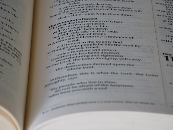 A close-up view of an open Bible, showing text in black print on white pages with a focus on the section discussing 'The remnant of Israel.' The text is clear and legible, with some portions bolded for emphasis.