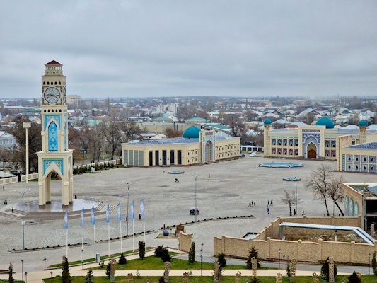 A large building with a clock tower in the middle of it — Turkistan, Kazakhstan