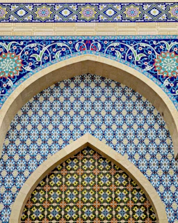 an ornate blue and green wall with a window