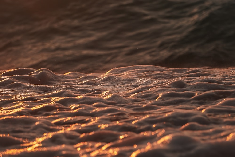 a close up of a wave on a beach