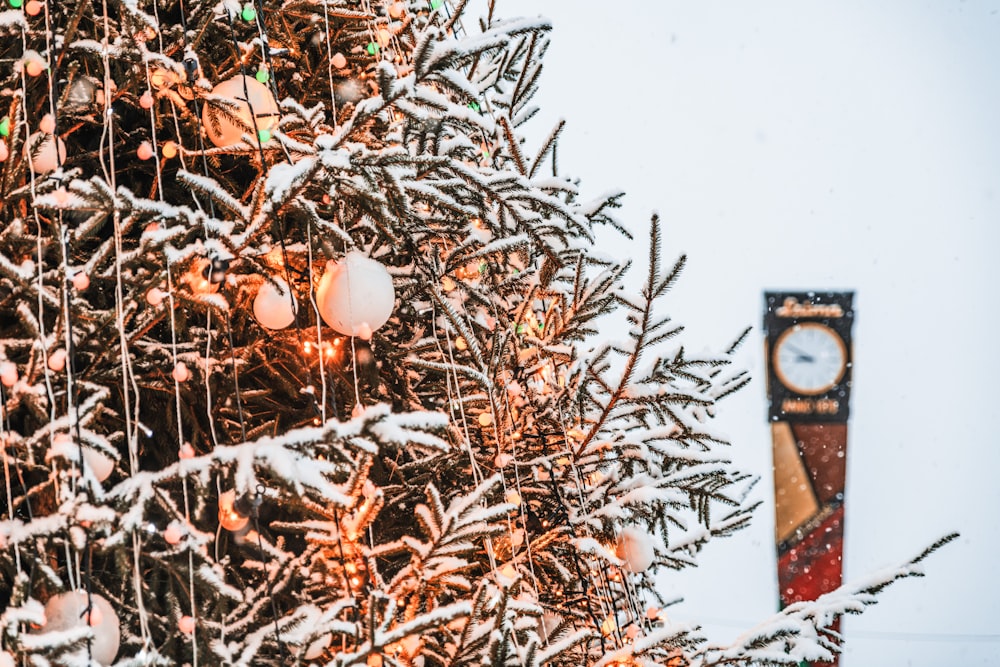 a christmas tree with a clock tower in the background