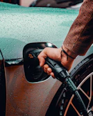 a man is pumping gas into his car