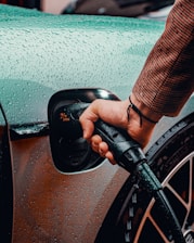 a man is pumping gas into his car