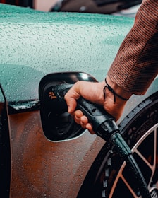 a man is pumping gas into his car