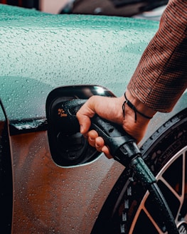 a man is pumping gas into his car