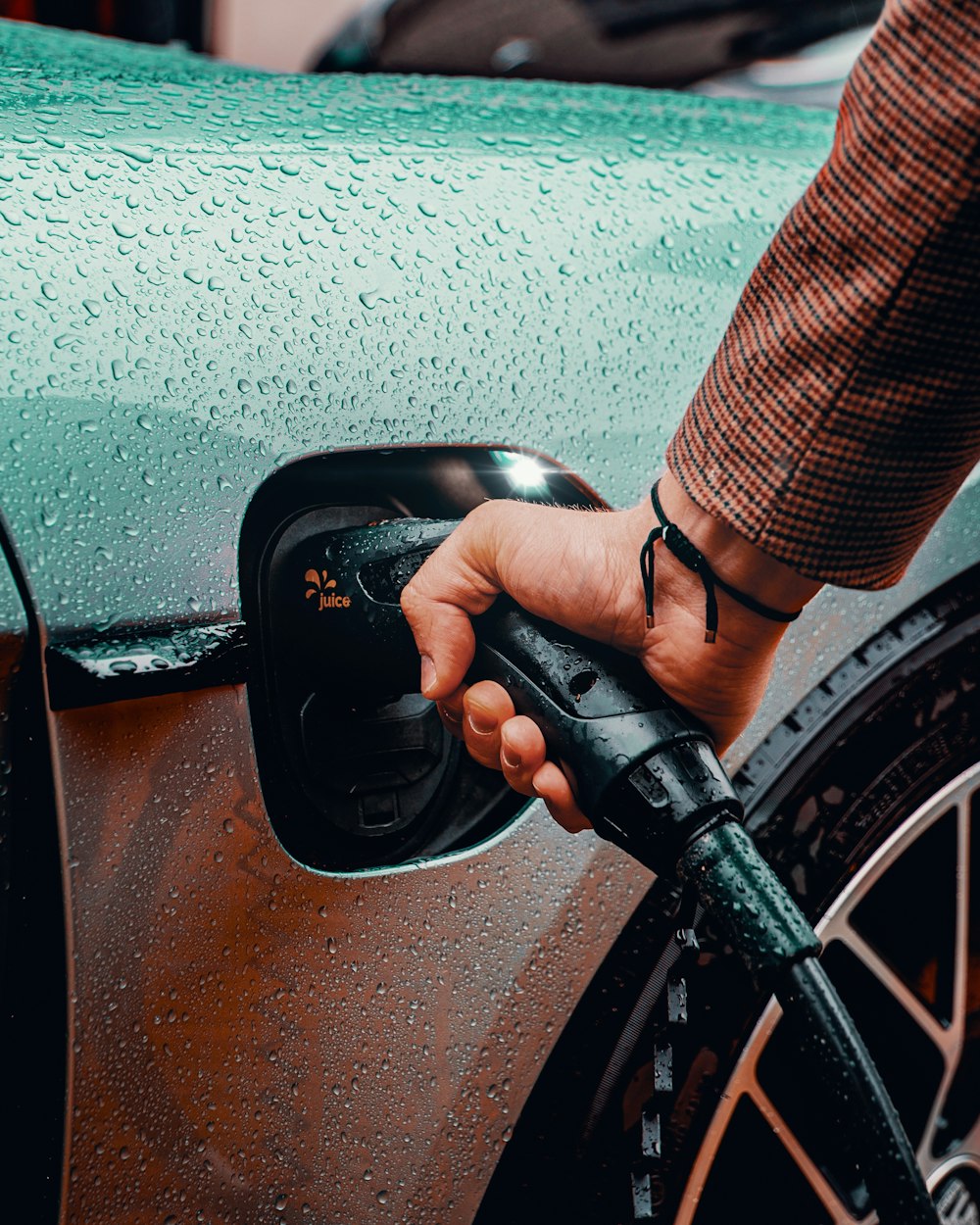 a man is pumping gas into his car