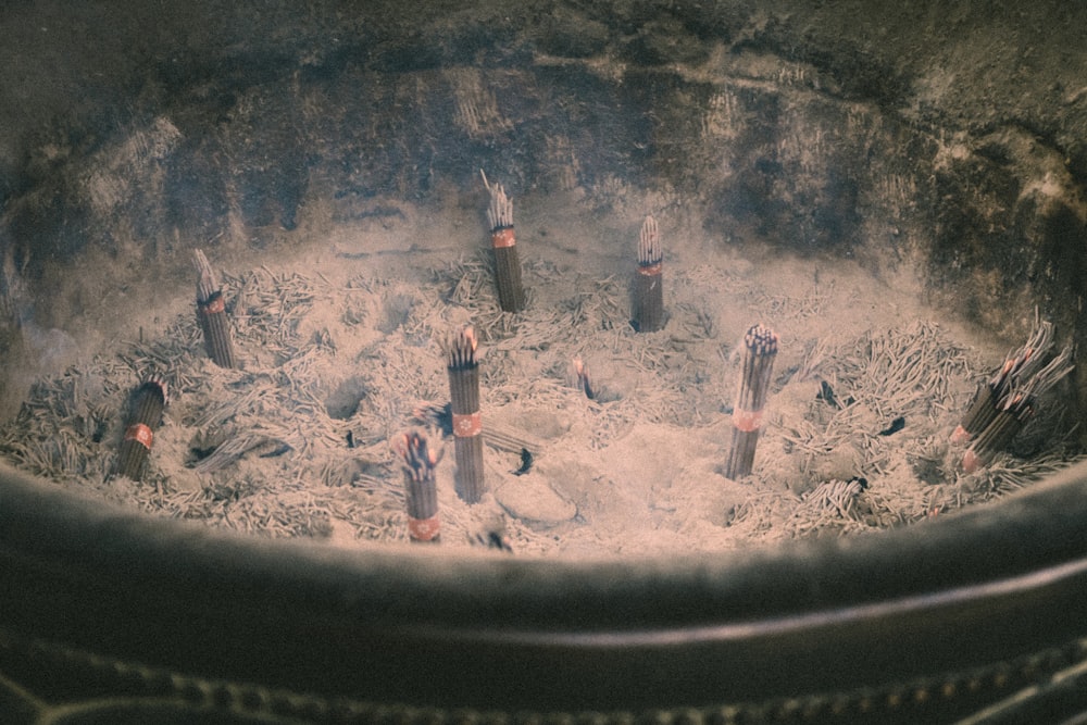 a close up of a fire pit filled with sand