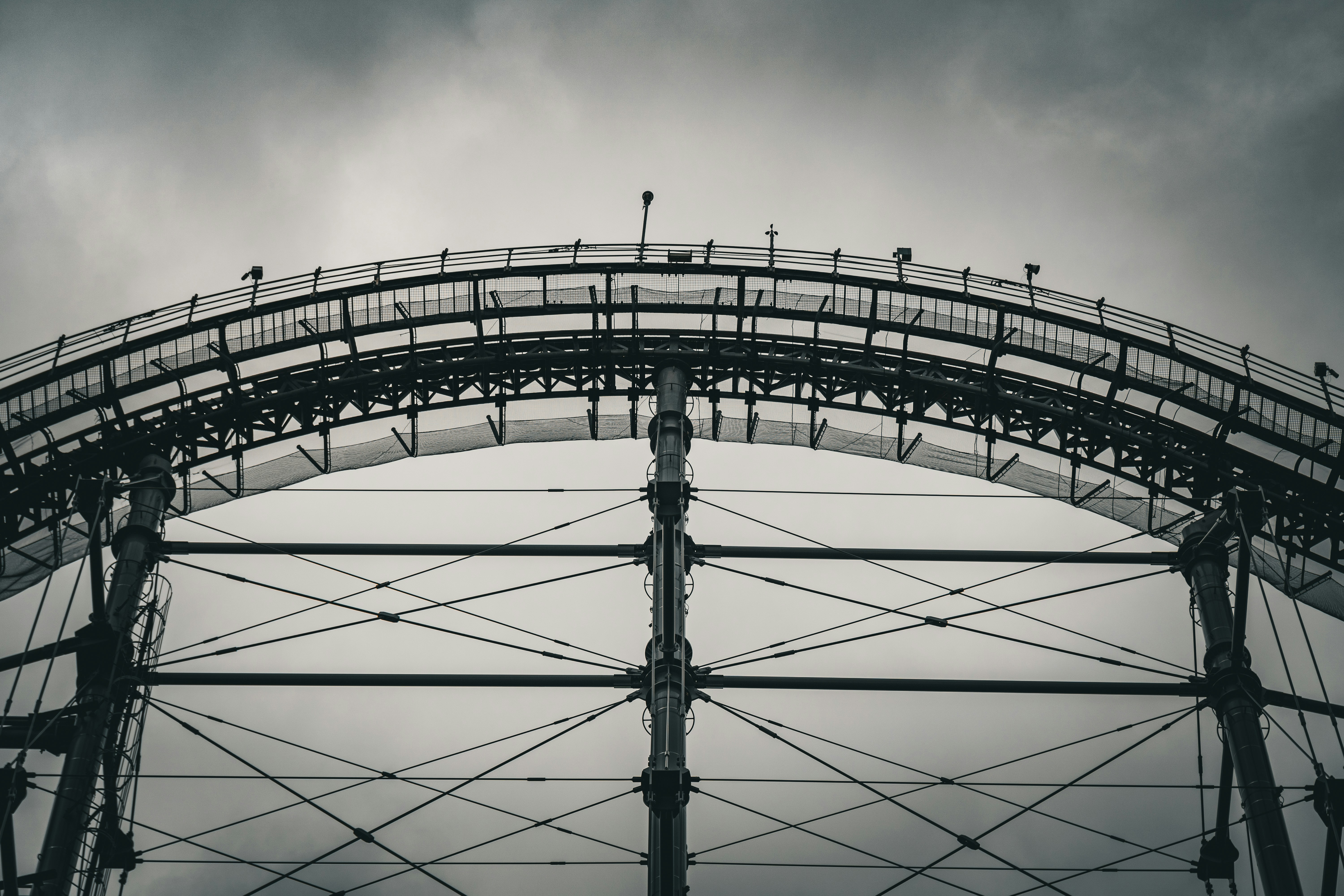 a large metal structure with a sky background, Roller coaster rail.