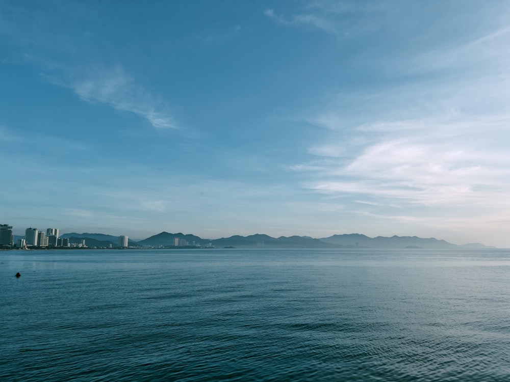 a body of water with a city in the background