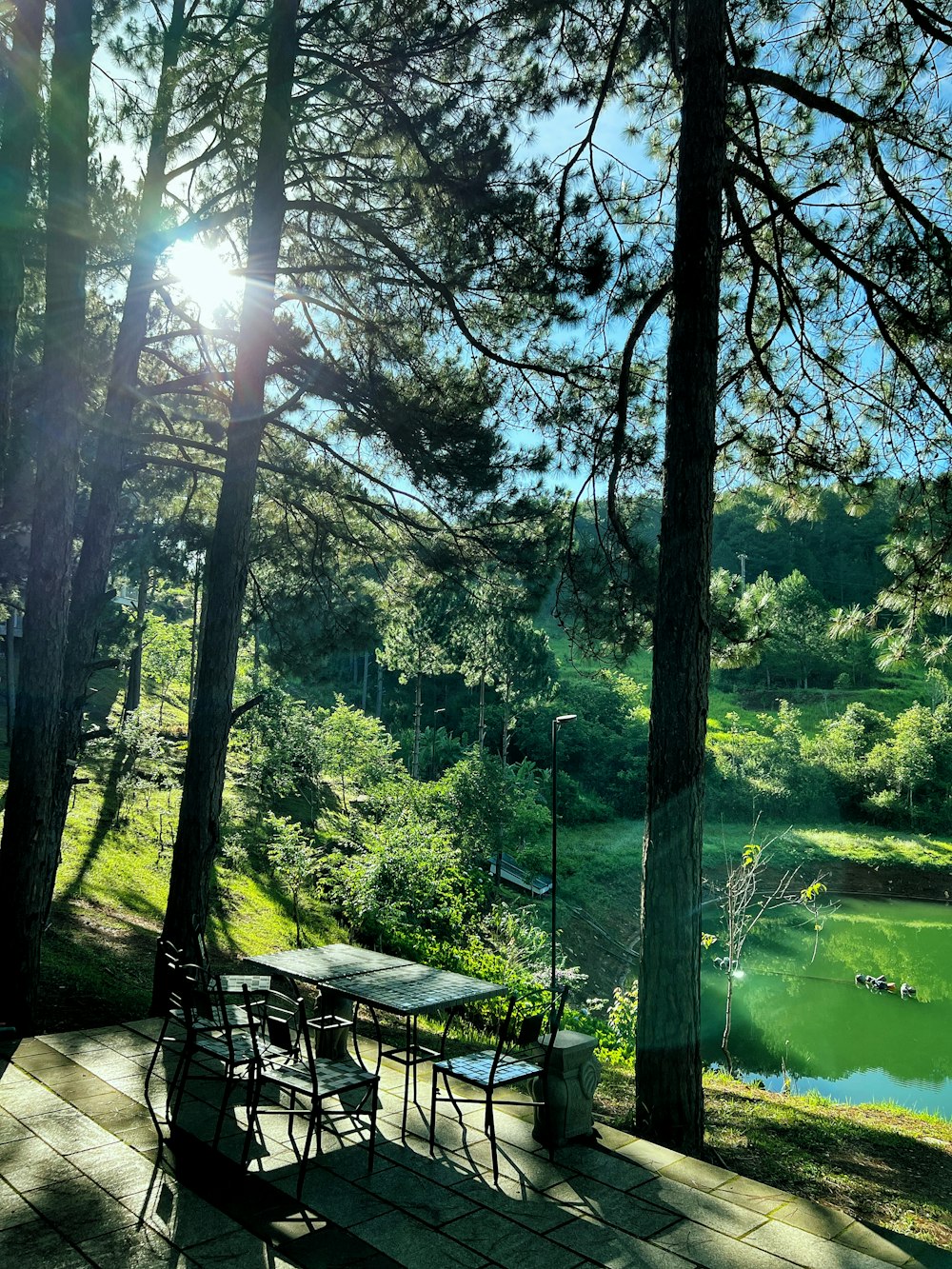 a table and chairs on a patio overlooking a lake