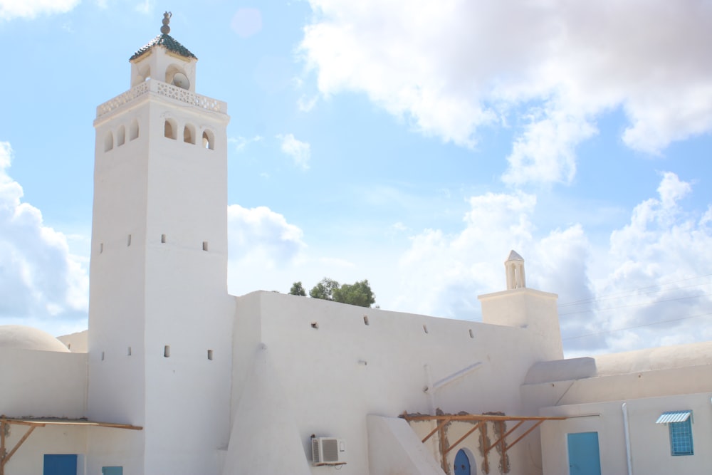 a large white building with a clock tower