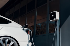 a white car plugged in to a charging station