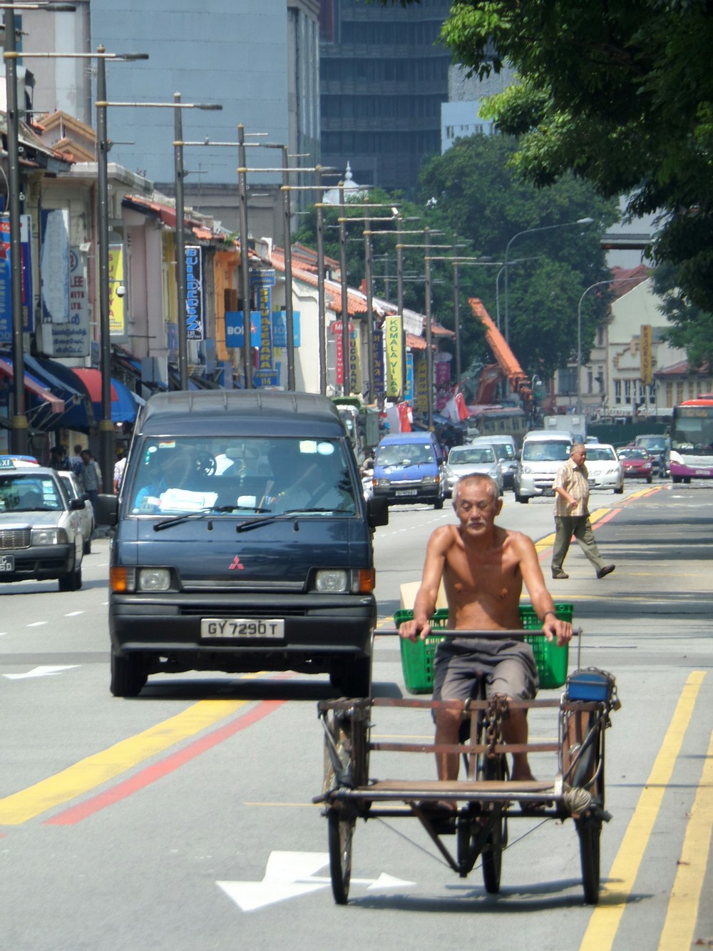 a man riding a cart down a street