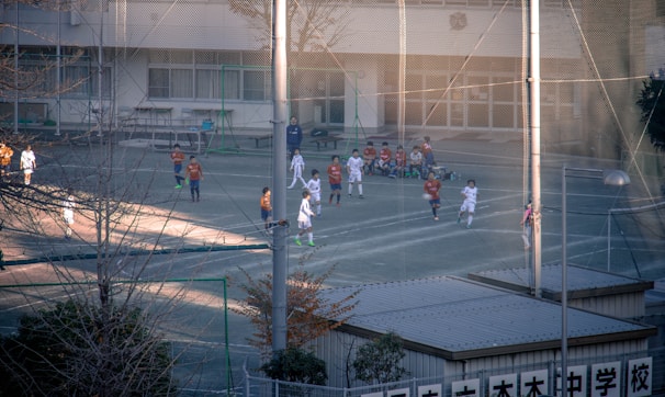 Children in colorful soccer uniforms joyfully competing on a sunny Saturday field.