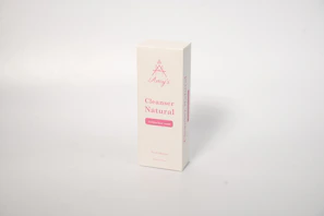 A product box standing upright against a plain light background. The box is labeled 'Amy's Cleanser Natural' and 'Gelatin face wash' in pink text. The overall design is simple and minimalistic.