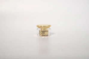 Peptide-infused cream in an elegant jar with a silver lid on a muted lavender background
