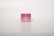 A small, pink box of regenerative cream stands on a plain, light background. The box has simple branding with white text.