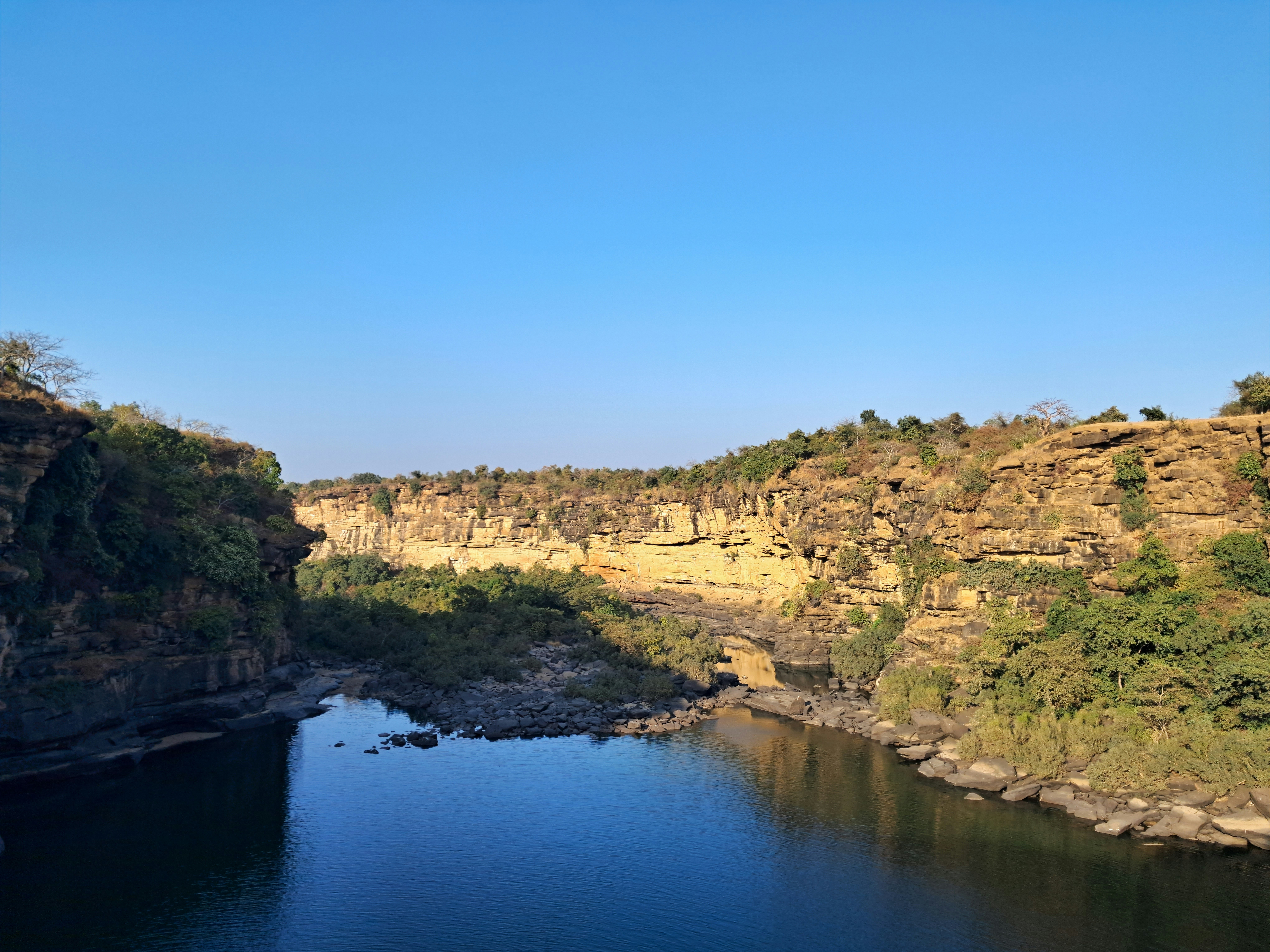 a body of water surrounded by rocky cliffs