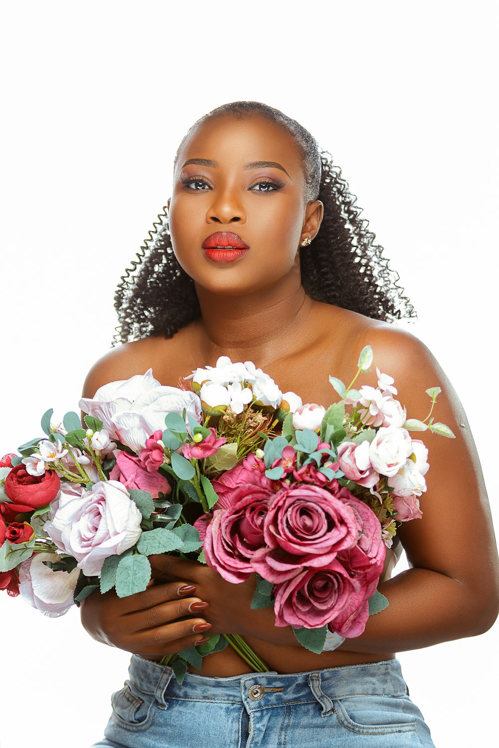 a woman holding a bouquet of flowers in her hands