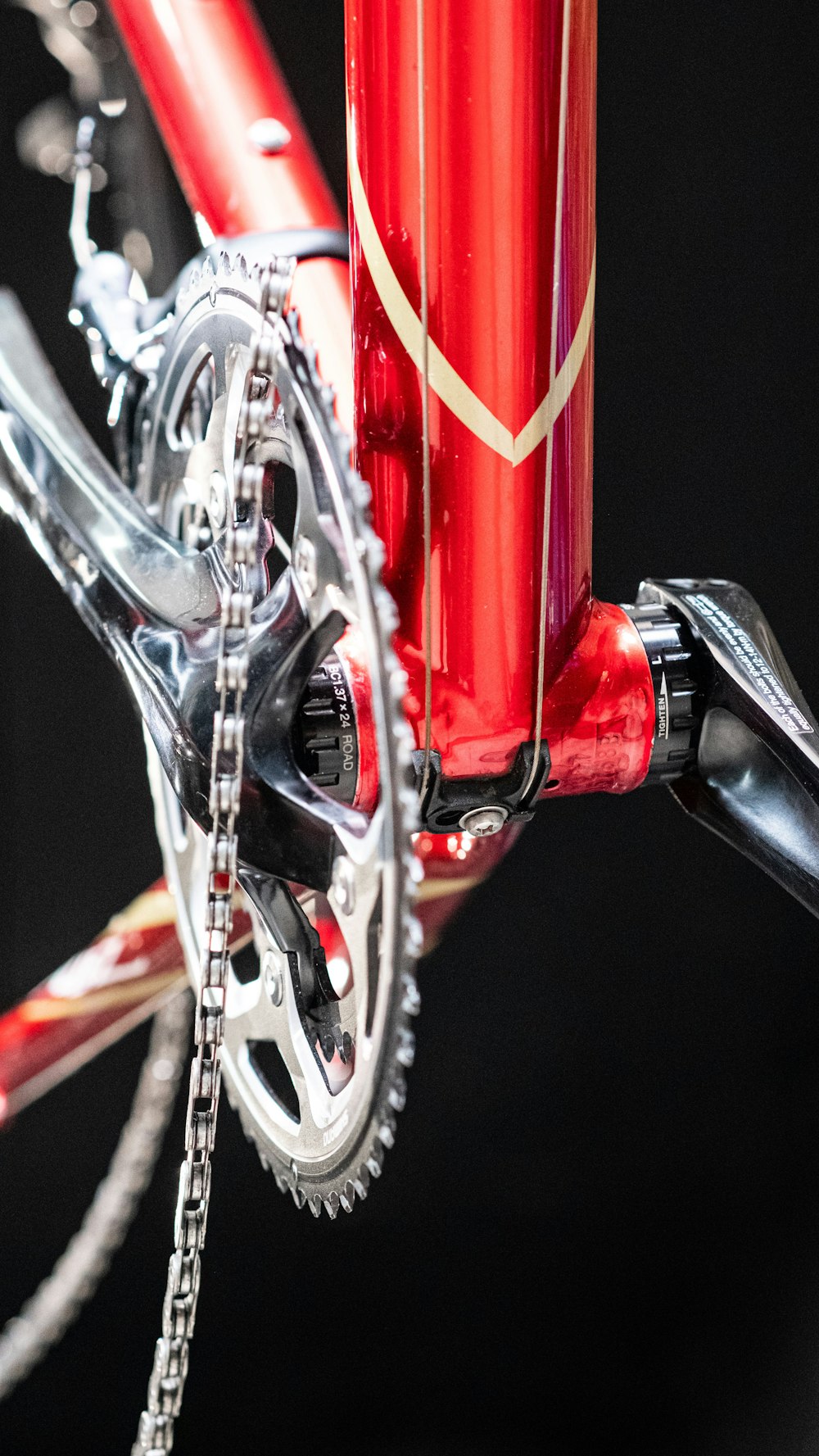 a close up of a red bike with a chain