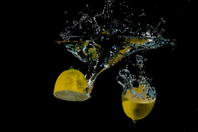 A splash of lemon juice captured mid-air over a white background.