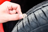 Technician inspecting a large commercial vehicle tyre before retreading.