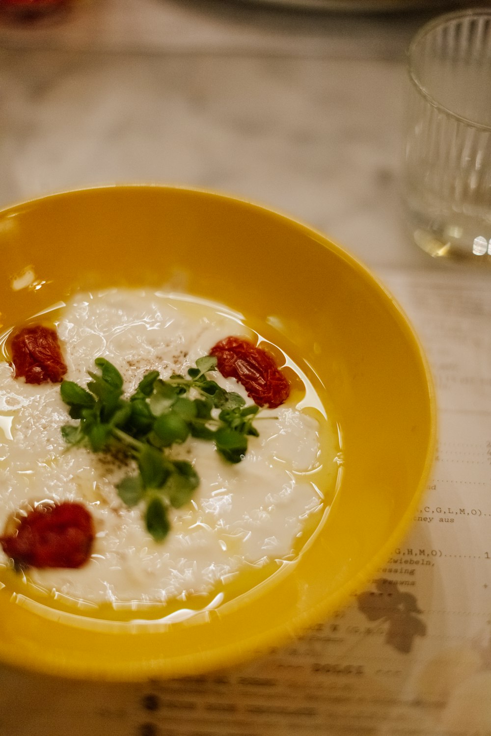 a yellow bowl filled with food on top of a table