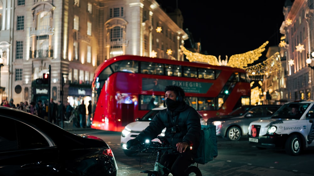 a man riding a bike down a city street