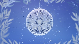 A close-up of bright, intricately designed 3D snowflake decorations hanging against a softly lit background.
