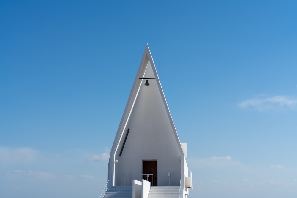 a white church with stairs leading up to it