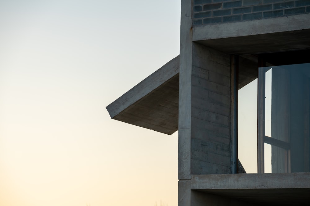 a view of a building from a window at sunset