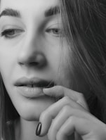 Close-up black and white portrait of a thoughtful woman reflecting deeply.