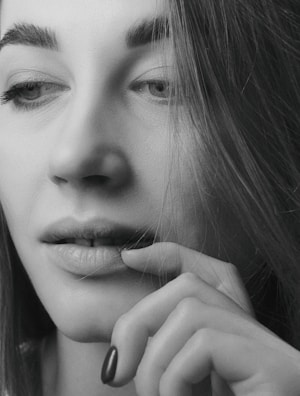 Close-up pencil sketch capturing the delicate expression of a young woman.