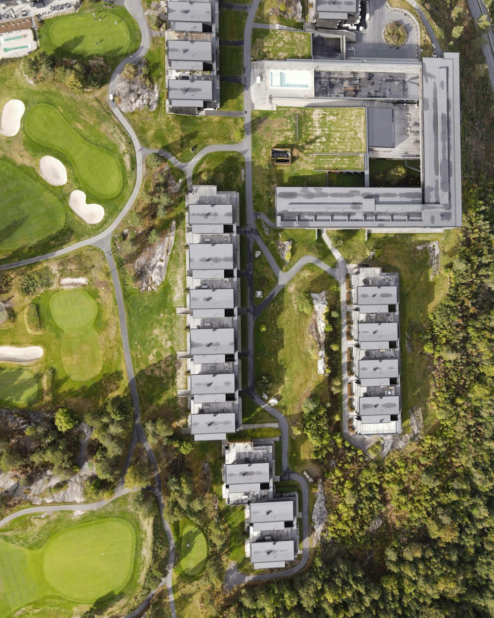 an aerial view of a building surrounded by trees